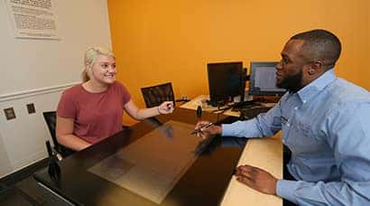 A Hendrick employee helping a customer through financing