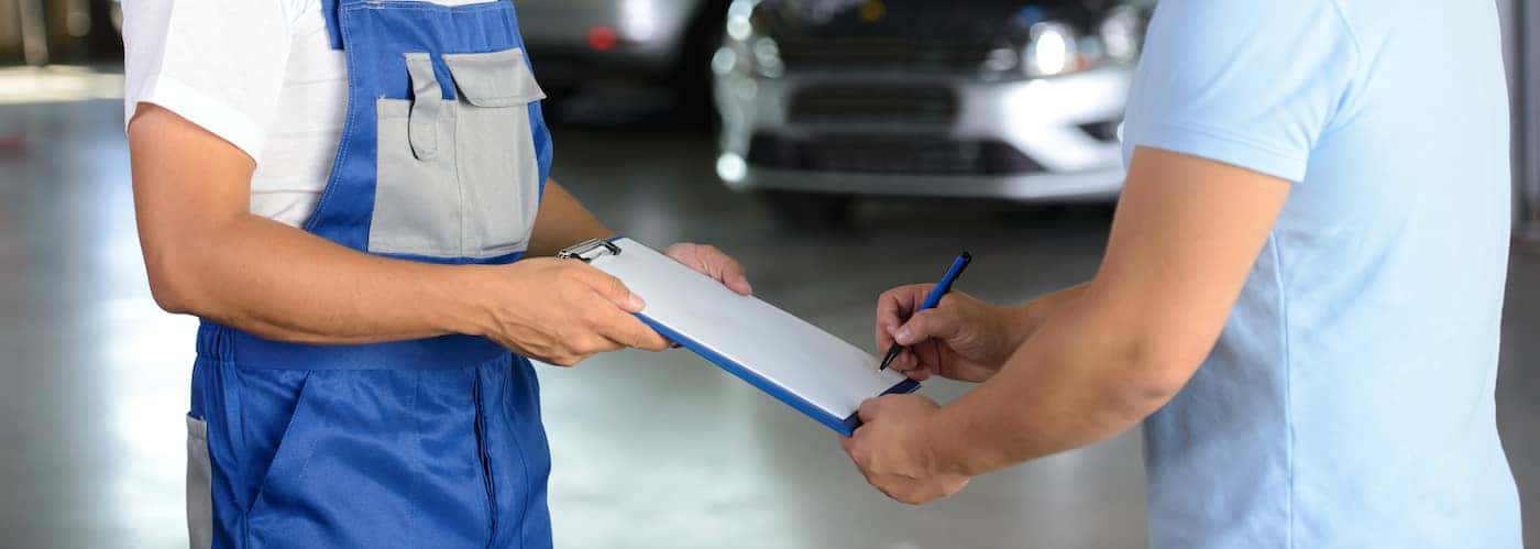 mechanic reviewing car service bill