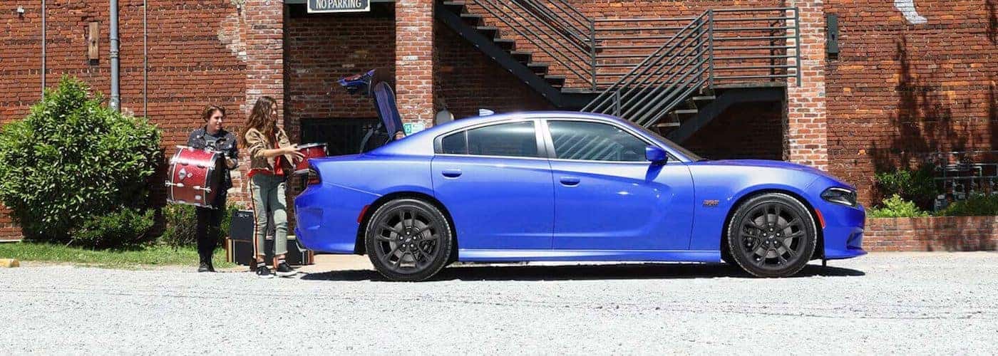 2020 dodge charger blue exterior parked and being loaded with drum equipment