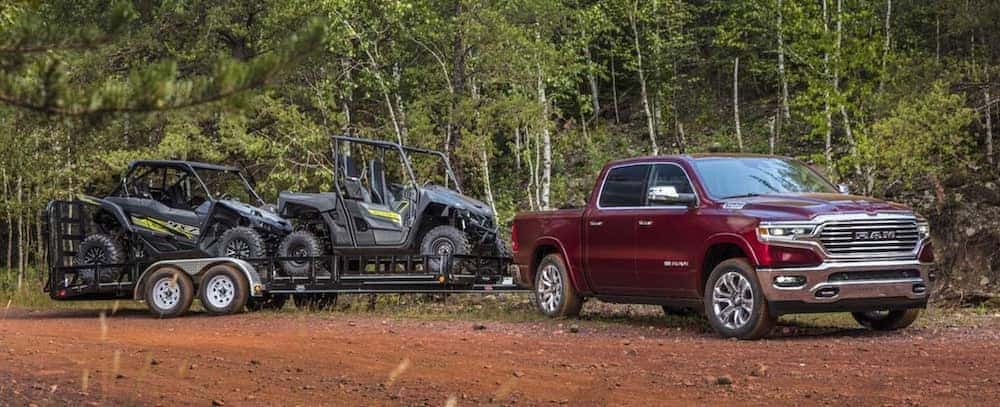 2021 ram 1500 red exterior pulling trailer