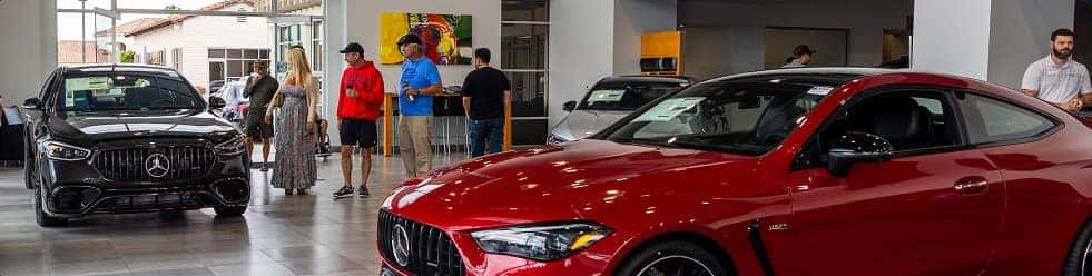 Guests and vehicles inside the Mercedes-Benz of Carlsbad showroom