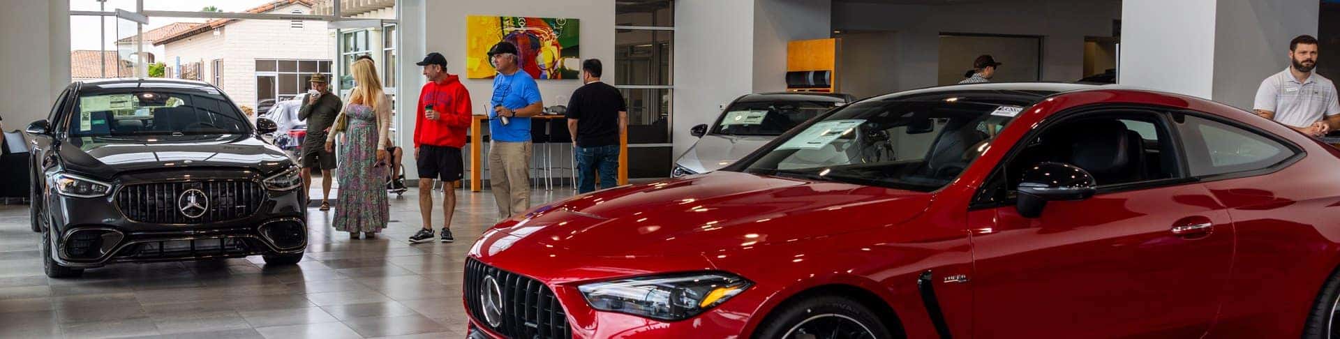 Guests and Mercedes-Benz vehicles inside the Mercedes-Benz Carlsbad showroom