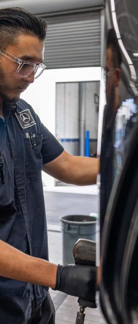 Mercedes-Benz service technician working on a vehicle