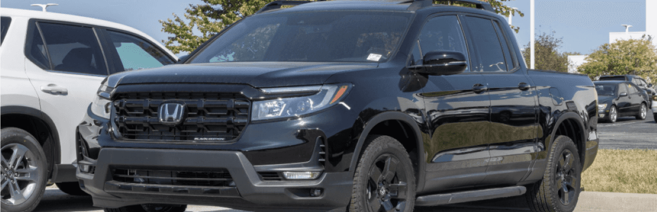 Nalley Honda Brunswick dealership with a selection of used trucks in the lot ready for sale.