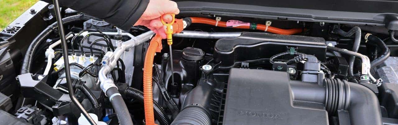 The Nalley Honda service team is performing an oil change with expert care.