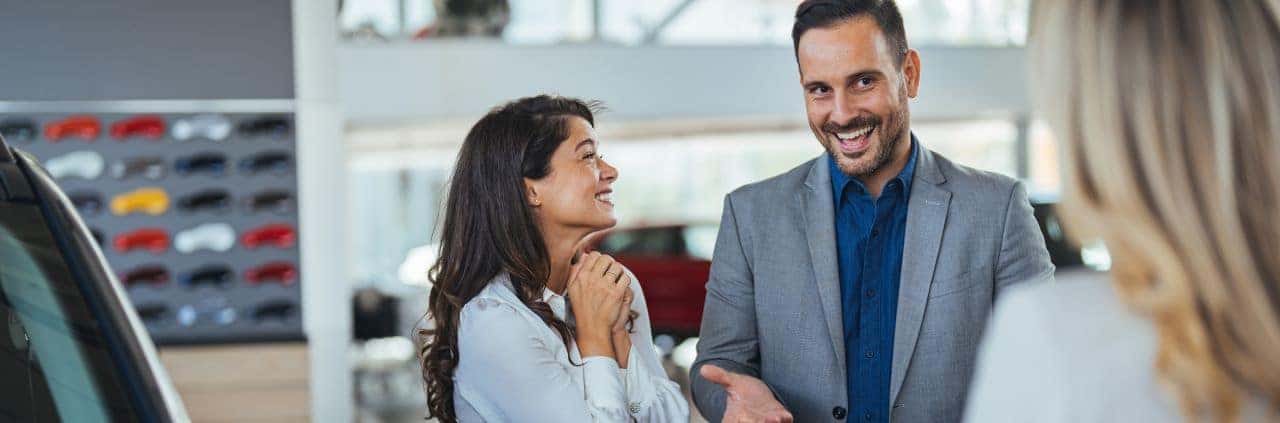 Friendly Nalley Honda Brunswick staff assisting a happy customer at the dealership.
