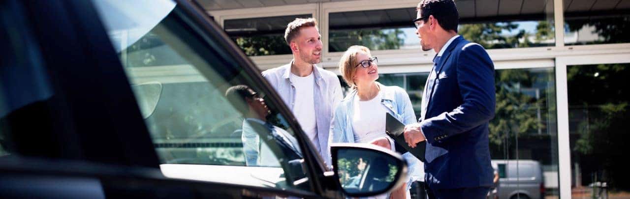 Inside Nalley Honda Brunswick, highlighting a friendly team assisting customers with Honda cars and services.