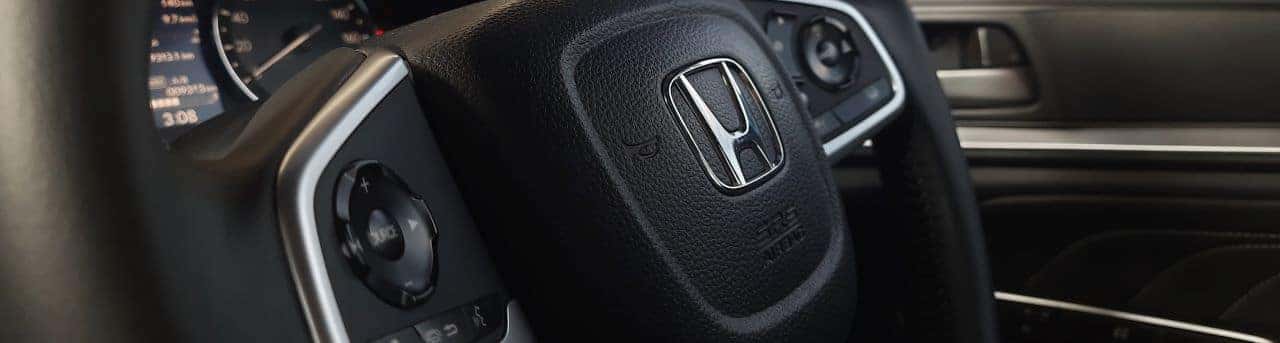 Honda auto parts counter showcasing genuine Honda parts with professional staff ready to assist customers.