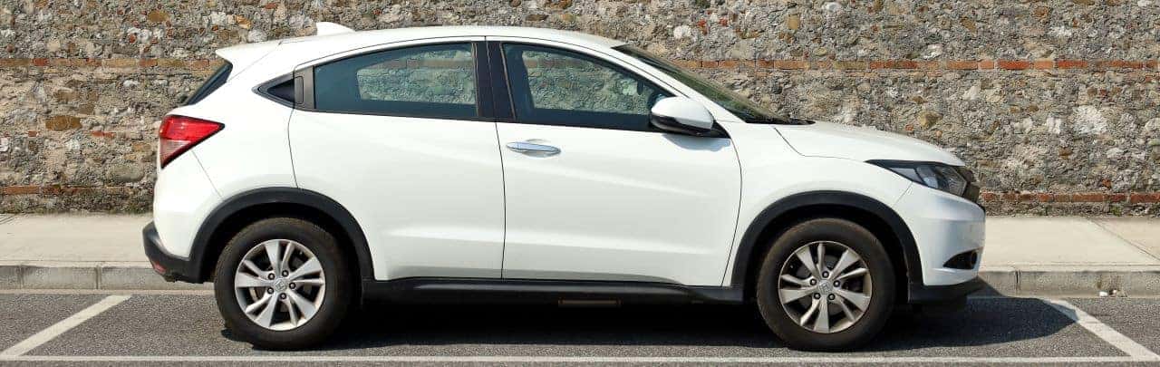 A customer reviewing a financing agreement at Nalley Honda Brunswick with a 2024 Honda SUV parked outside.
