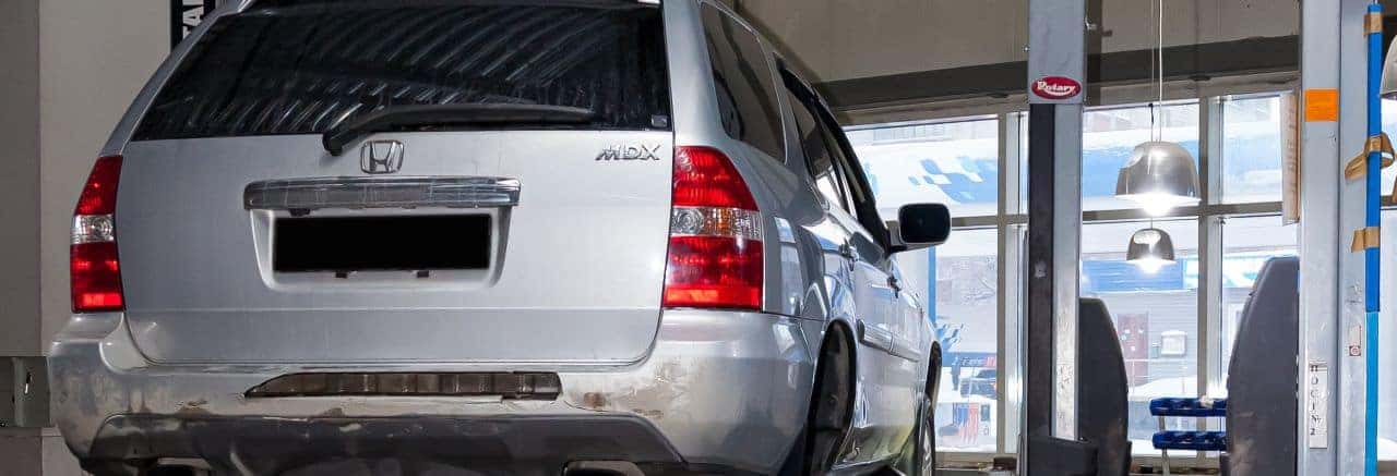The Nalley Honda service team works on an Acura vehicle in a state-of-the-art service bay.