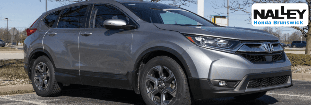 Used Honda CR-V parked at Nalley Honda Brunswick dealership, ready for sale.