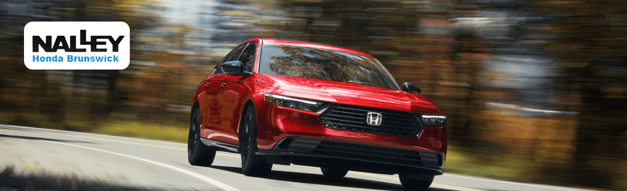 View of Nalley Honda Brunswick dealership exterior with lineup of new Honda models