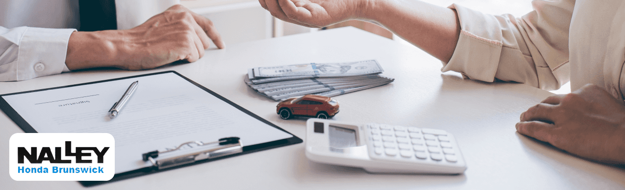 Customer trading in their Honda at Nalley Honda Brunswick while comparing the Kelley Blue Book value with the Max Allowance offers
