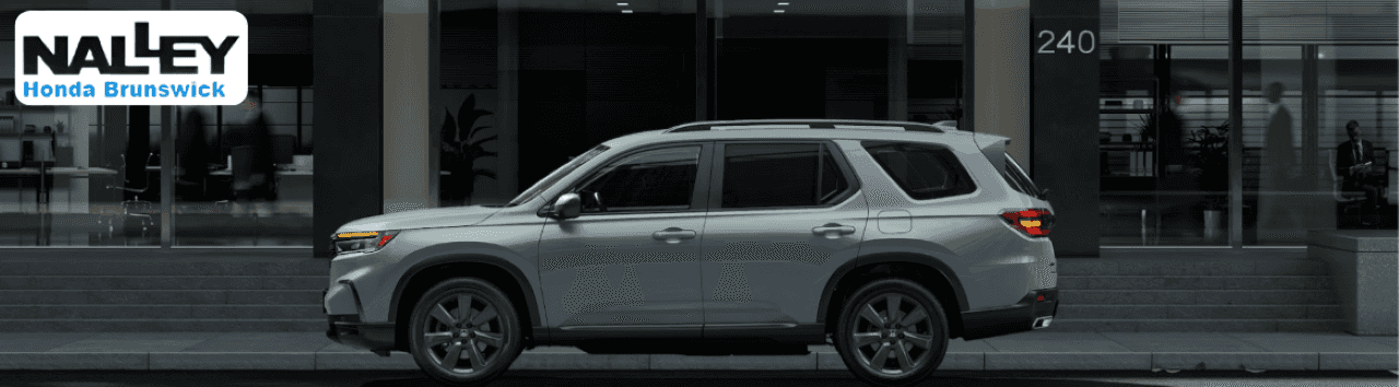 Family exploring the spacious interior of the Honda Pilot SUV in Brunswick, GA.