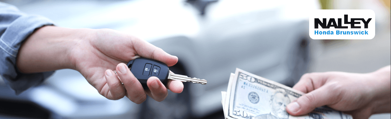Driver reviewing a higher MAX Allowance offer compared to CarMax at Nalley Honda Brunswick near Macon, GA.