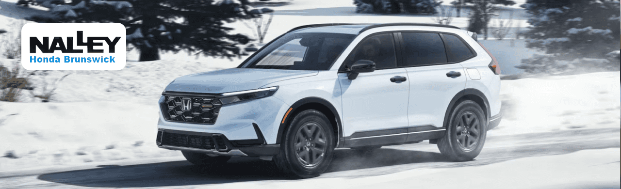 Used Honda CR-V models are parked in front of the Nalley Honda Brunswick showroom, ready for test drives.