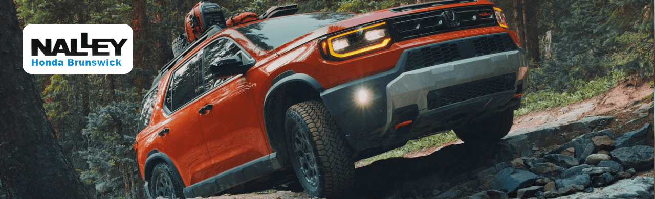 A driver exploring the advanced technology of the 2025 Honda Passport in Brunswick, GA.