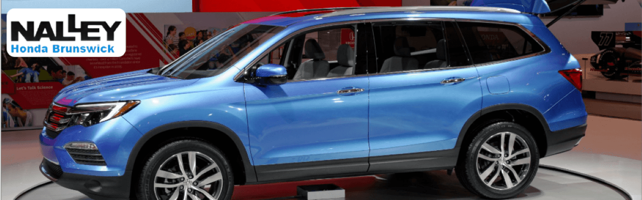 A front-facing image of Honda SUVs lined up outside Nalley Honda Brunswick, ready for test drives.
