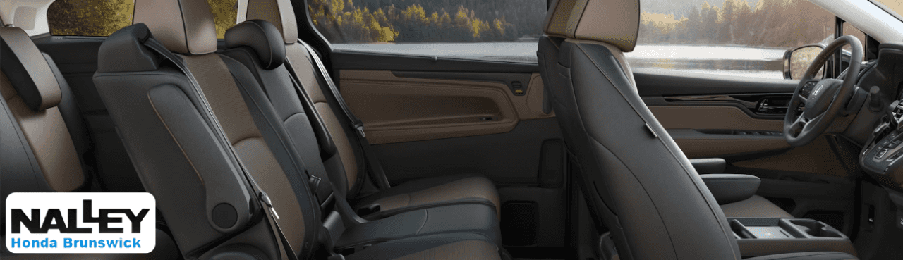 Interior view of the Honda Odyssey showcasing three-row seating and infotainment features.