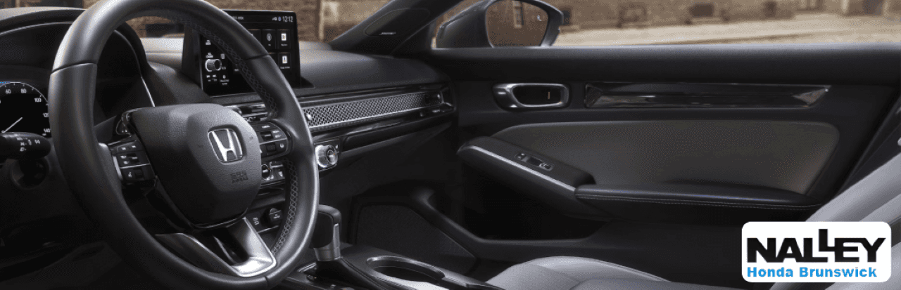 Interior of the Honda Civic Coupe showing modern infotainment and driver-focused design ideal for everyday Georgia driving.