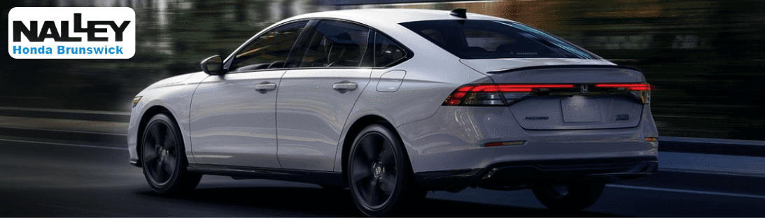 2025 Honda Accord Hybrid Touring driving through Brunswick, GA, highlighting its sleek exterior design and hybrid performance.