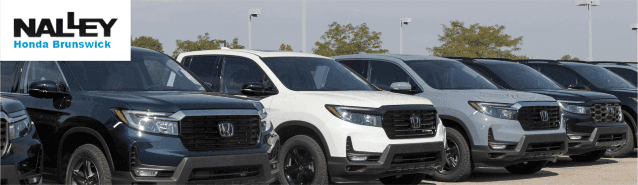 Used Honda Ridgeline pickup trucks parked at a dealership in Brunswick Georgia