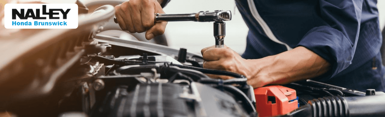 Honda technician performing scheduled maintenance on a Civic at Nalley Honda Brunswick in Brunswick, GA