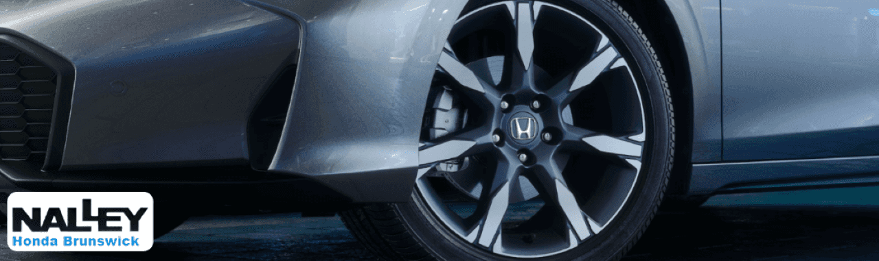 2026 Honda Civic Hatchback Hybrid parked outside Nalley Honda Brunswick showroom in Brunswick, GA.