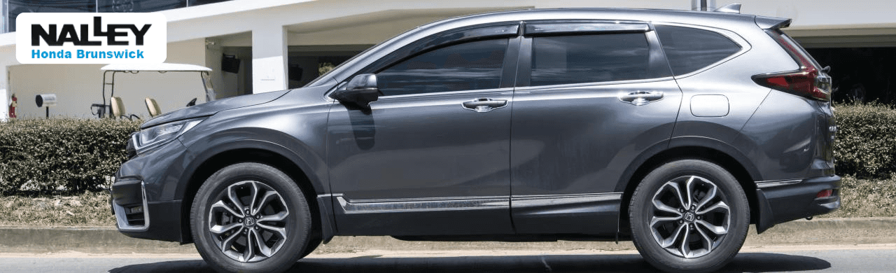 Customer viewing used Honda SUVs with a sales advisor in the Brunswick, GA dealership