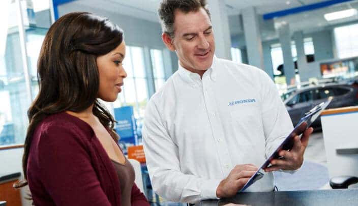 Honda sales associate shows customer available options
