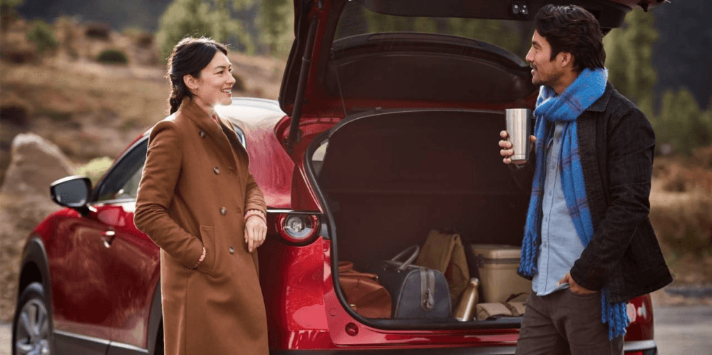Couple loading cargo in a Mazda SUV