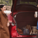 Couple loading cargo in a Mazda SUV