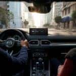 A driver and passenger using Mazda Connect