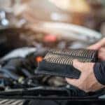 Mechanic demonstrating how often to change the engine air filter