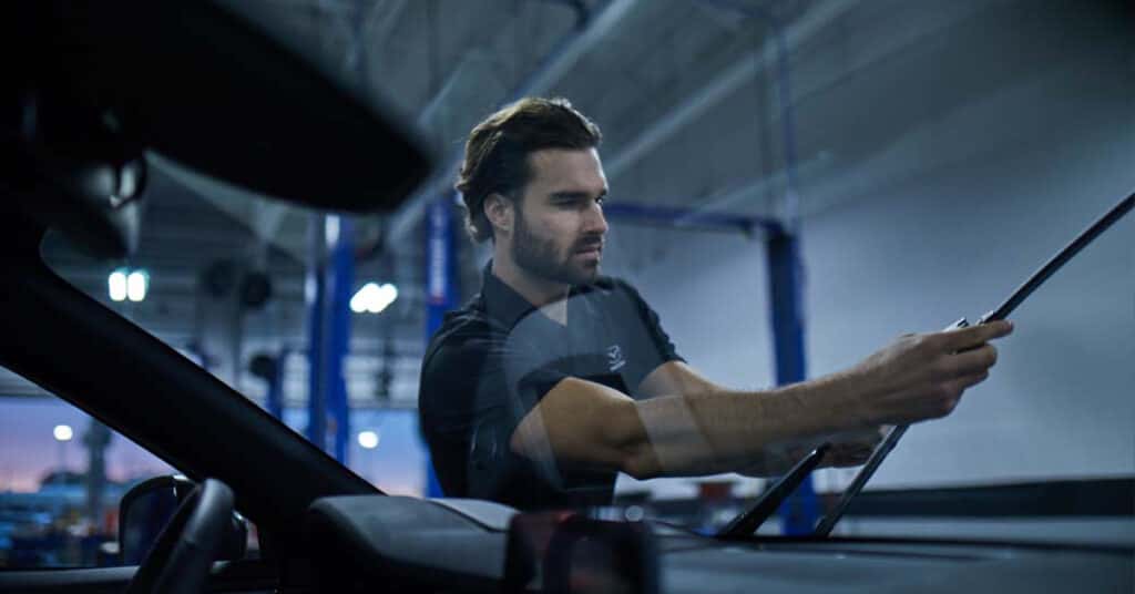 Mazda service technician replacing windshield wipers