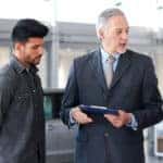 Couple speaking with a Mazda financing team member about refinancing