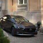 The 2026 Mazda3 Sedan going down an incline in the city