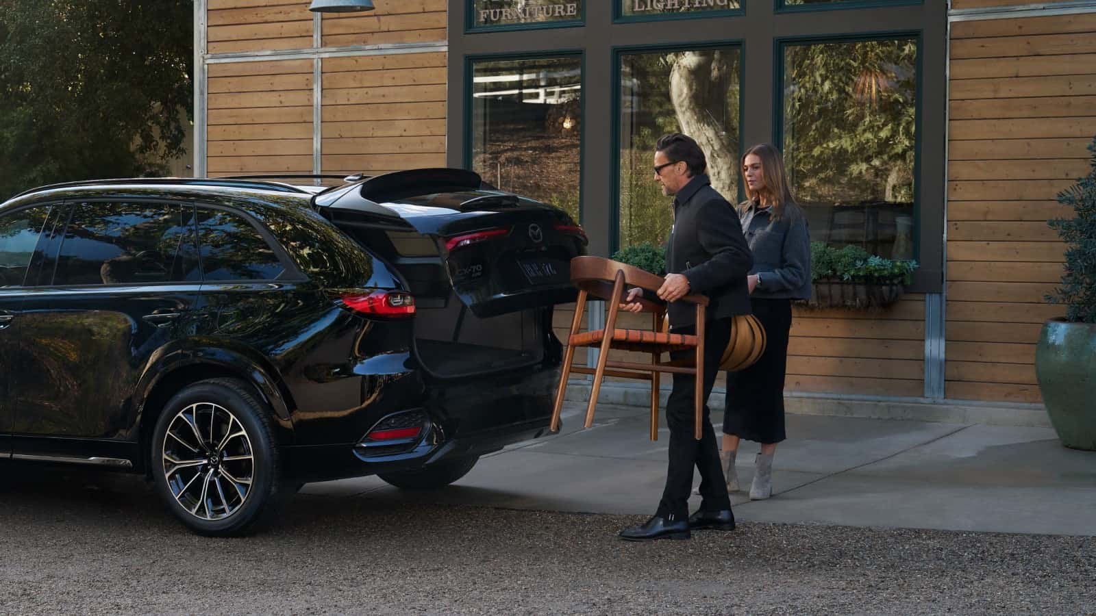 Couple loading chair into 2026 Mazda CX-70 trunk