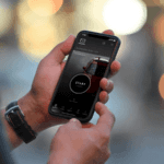 Hands holding phone displaying MyMazda app