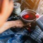 Mechanic changing transmission fluid