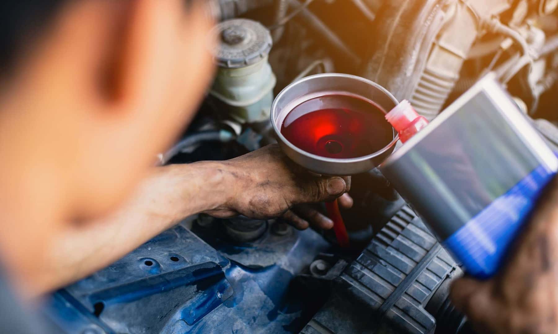 Mechanic changing transmission fluid