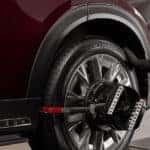 Mazda service technician performing wheel balancing