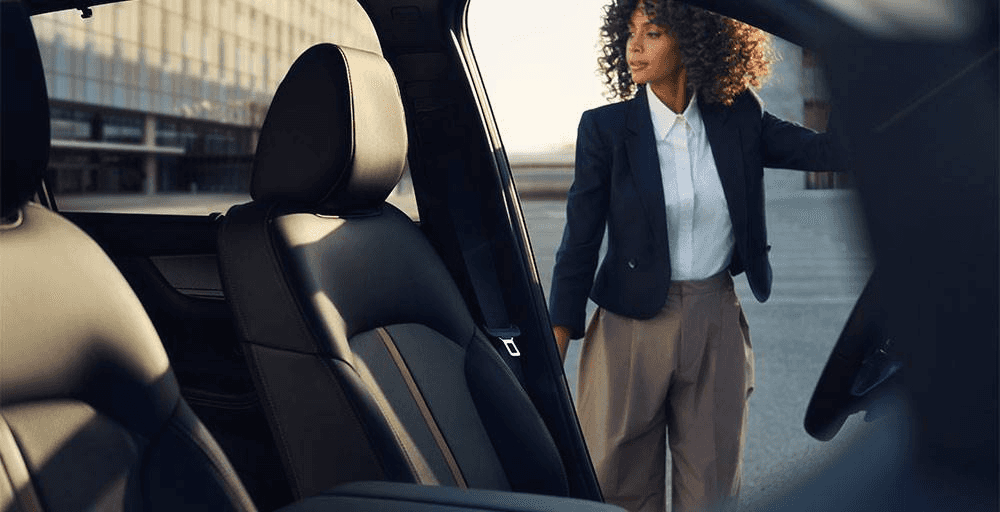 woman entering a 2024 Mazda CX-90