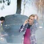 Car breakdown woman call for help road assistance smoking engine