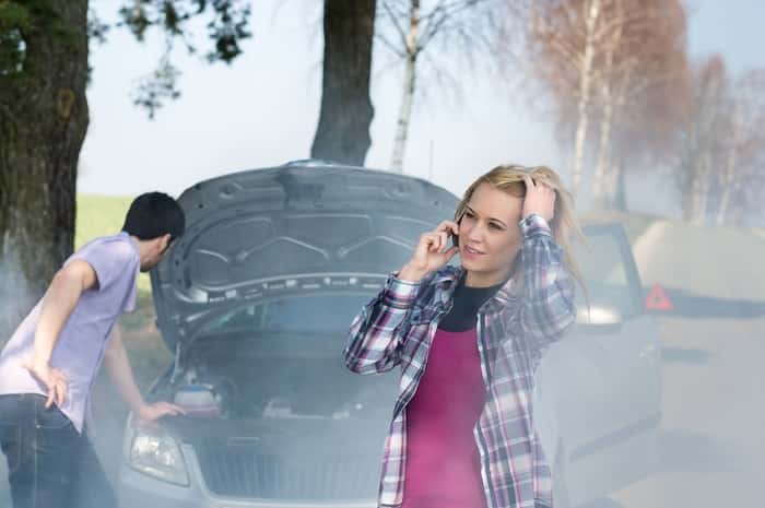 Car breakdown woman call for help road assistance smoking engine
