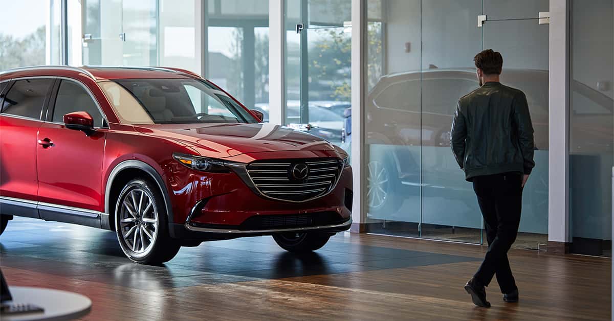 Man walking through Mazda dealership