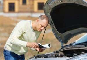 Person by broken-down car