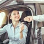Woman receiving car keys thanks to Volkswagen financing
