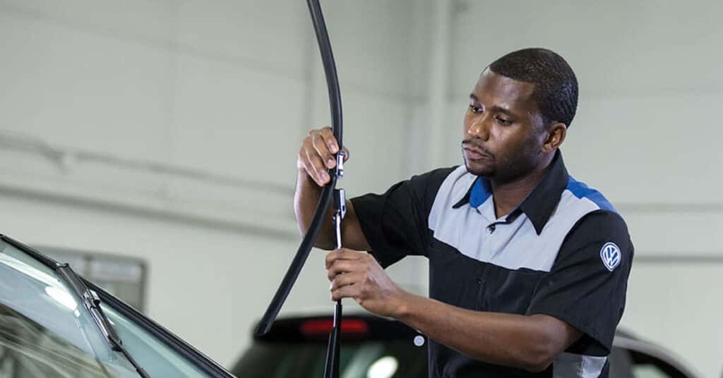 Volkswagen service technician replacing windshield wipers