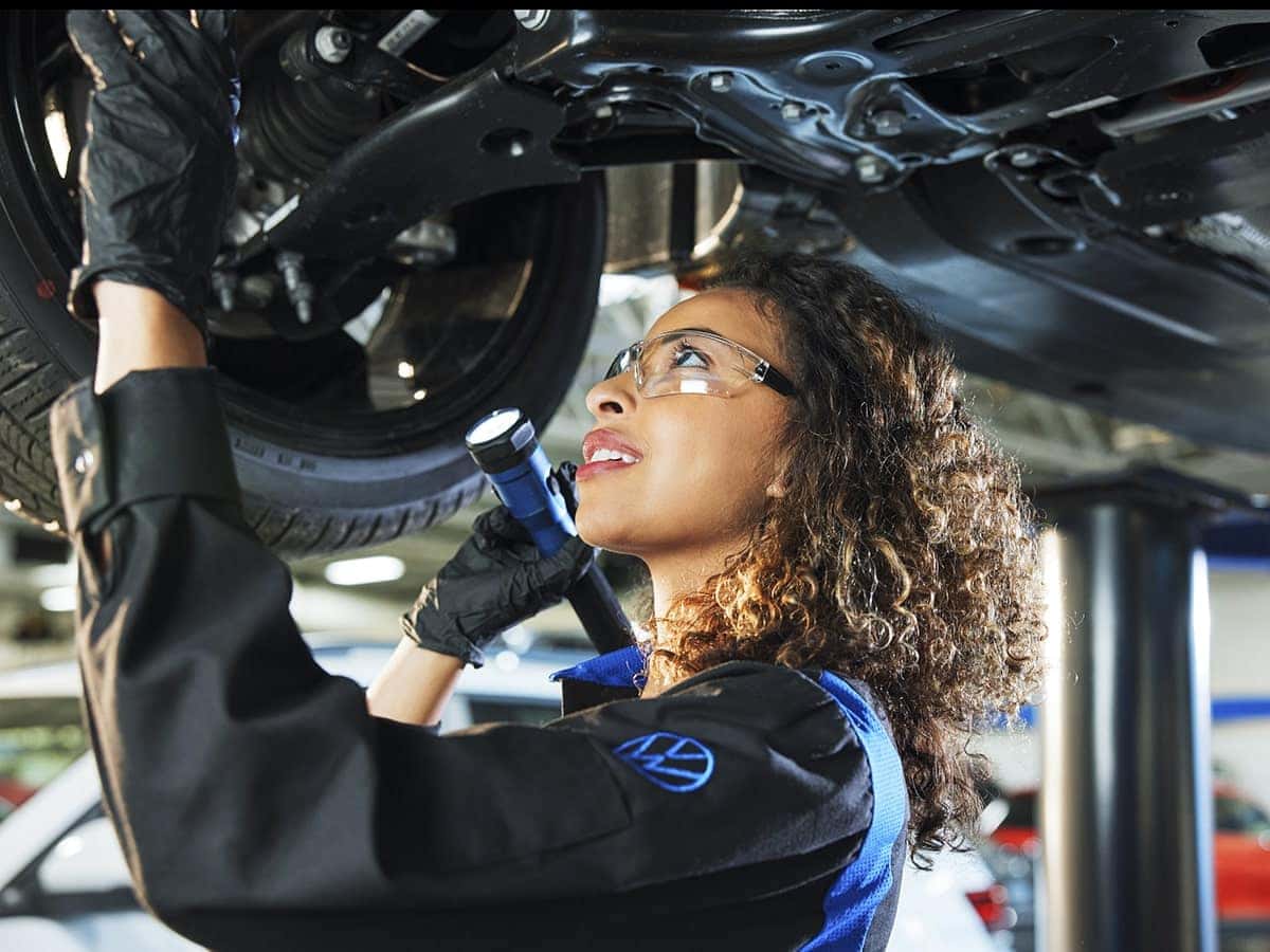 North Penn Volkswagen Technician inspecting tire